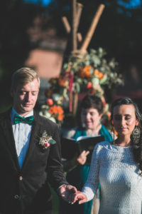 Alternate bridal couple at spiritual wedding ceremony outdoors, half portrait