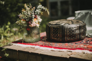 Hassocks and floral decoration at alternative wedding celebration, close up