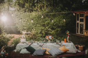 Festive laid table at alternative wedding celebration outside