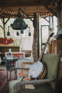 garden shed, inside, furnishing, armchair, banjo, string of lights