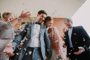 Wedding, bridal couple and guests celebrate with confetti