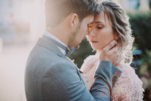 Bridal couple outside, touching, in love, portrait, back light,