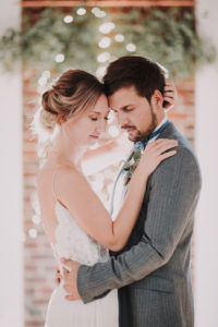 Happy bridal couple, hug, closed eyes, half portrait, side view, 