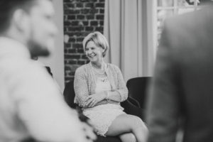 Elderly woman, sitting, smiling, looking sideways, blurring,