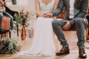 Bridal couple, sitting, holding hands, detail,
