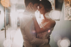 Bridal couple in love, hug, half portrait, detail, back light,