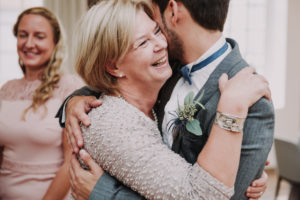 Wedding, groom and senior woman, hug, smile,