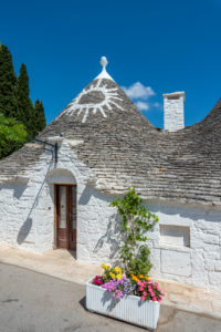 Alberobello, Bari province, Salento, Puglia, Italy, Europe. The typical trulli houses with their cone-shaped roof and the symbols