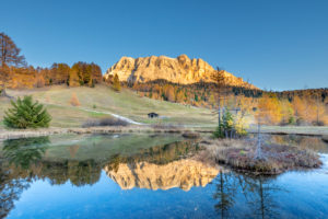 Hochabtei / Alta Badia, Provinz Bozen, Südtirol, Italien, Europa. Sonnenuntergang über den Armentarawiesen. In einem kleinen Bergsee spiegeln sich die Gipfel der Zehnerspitze und des Heiligkreuzkofel Hochabtei / Alta Badia, Provinz Bozen, Südtirol, Italien, Europa. Sonnenuntergang über den Armentarawiesen. In einem kleinen Bergsee spiegeln sich die Gipfel der Zehnerspitze und des Heiligkreuzkofel