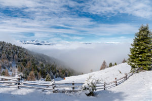 Percha, Bolzano province, South Tyrol, Italy. Snow in spring above the Gönner Alm. In the background the Dolomites Percha, Bolzano province, South Tyrol, Italy. Snow in spring above the Gönner Alm. In the background the Dolomites