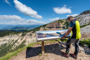 Aldein, Province of Bolzano, South Tyrol, Italy. Geoparc Bletterbach. A panorama board above the Gorz, the end of the Bletterbach gorge Aldein, Province of Bolzano, South Tyrol, Italy. Geoparc Bletterbach. A panorama board above the Gorz, the end of the Bletterbach gorge