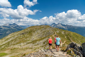 Sand in Taufers, Bolzano Province, South Tyrol, Italy. Hikers on the panorama trail in the Speikboden hiking area. Sand in Taufers, Bolzano Province, South Tyrol, Italy. Hikers on the panorama trail in the Speikboden hiking area.