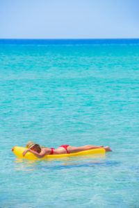 Woman relaxing on inflatable mattress, Formentera, Balearic Islands, Spain Woman relaxing on inflatable mattress, Formentera, Balearic Islands, Spain