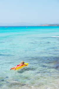 Woman relaxing on inflatable mattress, Formentera, Balearic Islands, Spain Woman relaxing on inflatable mattress, Formentera, Balearic Islands, Spain