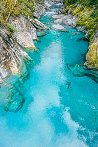 View of the blue pools on the Marokopa River, Haast Pass, Mount Aspiring National Park, Otago Region, South Island, New Zealand