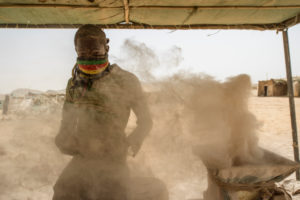 Gold prospectors at work in the Delgo gold market in the Sahara, Sudan