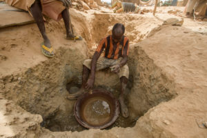 Gold prospectors at work in the Delgo gold market in the Sahara, Sudan