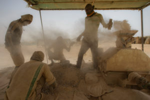 Gold prospectors at work in the Delgo gold market in the Sahara, Sudan