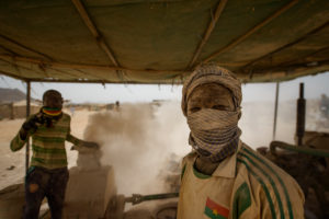 Gold prospectors at work in the Delgo gold market in the Sahara, Sudan