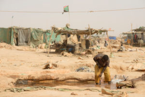 Gold prospectors at work in the Delgo gold market in the Sahara, Sudan