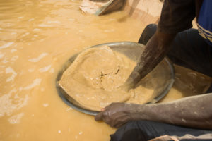 Gold prospectors at work in the Delgo gold market in the Sahara, Sudan