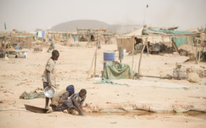 Gold prospectors at work in the Delgo gold market in the Sahara, Sudan