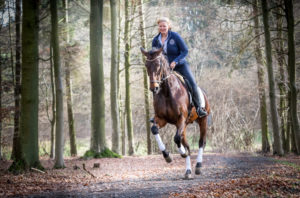 young woman riding through the forest young woman riding through the forest