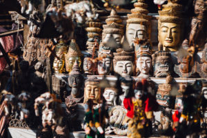 Various Burmese statues/masks on display at market in Bagan, Myanmar