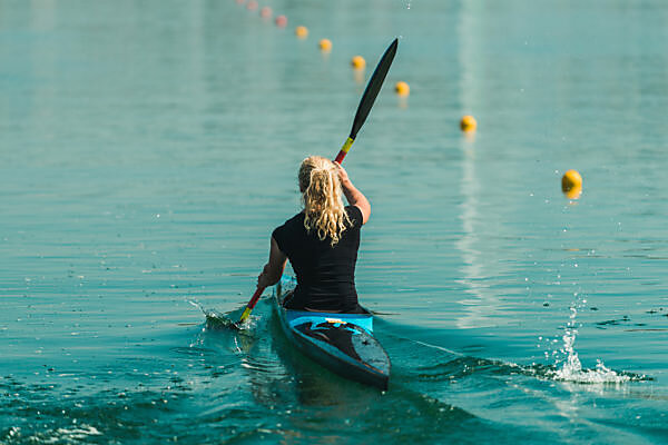 Boy fishing in a lake with a bow and arrow, Lago Miwa, as