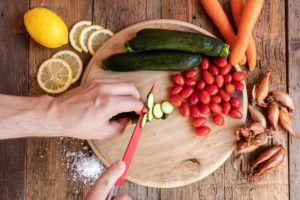 Chef cuts fresh vegetables essential ingredients of typical and healthy Italian cuisine Chef cuts fresh vegetables essential ingredients of typical and healthy Italian cuisine