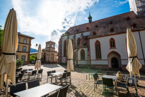 Morgens auf dem Platz vor der Stiftskirche, im Vordergrund Tische und Stühle von einem Restaurant. Morgens auf dem Platz vor der Stiftskirche, im Vordergrund Tische und Stühle von einem Restaurant.