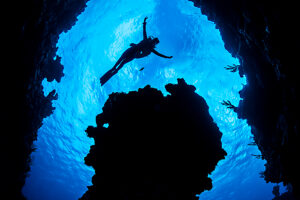 Diver exploring a coral reef,Grand Cayman,Cayman Islands,Caribbean Sea