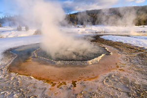 Steam rising from Crested Pool hot spring in winter,Upper Geyser Basin,Yellowstone National Park,Wyoming,USA.  