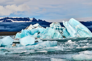 Icebergs in glacial lagoon with glacier in background,Jokulsarlon ice lagoon,Vatnajokull National Park,Iceland. 