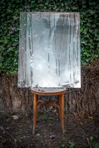 Poetic image of reflections in a garden and forest with a wooden chair in an atmosphere of a dream Poetic image of reflections in a garden and forest with a wooden chair in an atmosphere of a dream