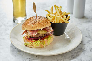 Bacon cheese burger with fries and beer