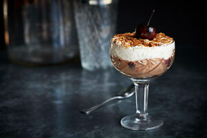 Modern take on a black forest gateaux dessert in a ornate glass