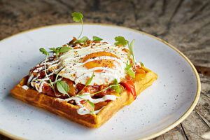 A savoury waffle with a fried egg