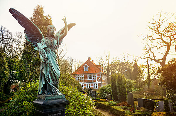 Tomb angel and parsonage of St. Pankratius in Ochsenwerder, Hamburg, Germany, Europe Tomb angel and parsonage of St. Pankratius in Ochsenwerder, Hamburg, Germany, Europe