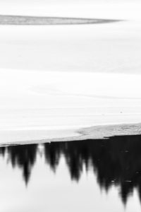Sweden, winter, reflexion in the water with ice, snow and trees Sweden, winter, reflexion in the water with ice, snow and trees
