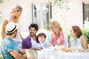 Friends enjoying meal and talking outdoors