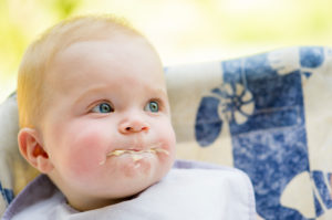 Messy baby eating, portrait