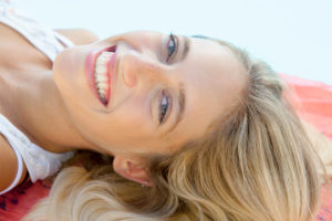 Woman relaxing at poolside, portrait
