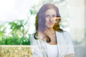 Businesswoman looking out of window from office