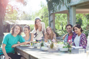 Friends enjoying weekend meal together, portrait