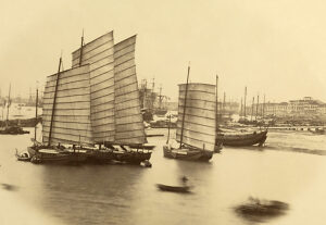 Junks, China. Photograph by Felice Beato (English, born Italy, 1832-1909), circa 1860. Albumen silver print. A row of Chinese junks moored in a harbor; one has run aground at low tide. In the background are Western sailing ships./n