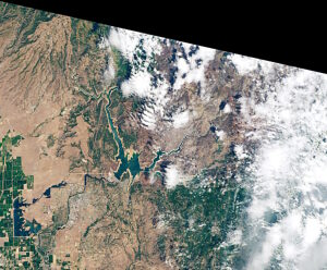 This image of California's  Lake Oroville,the state's second largest reservoir,was captured by the Operational Land Imager (OLI) on Landsat 8 on June 9,2021. From 2019 to 2021,because of historic drought conditions,the reservoir's  water level fell 190 feet (58 meters),from 895 to 705 feet above sea level (see images SS1260032 and SS1260045 for comparison). The tan fringes are areas of the lakebed that would be underwater if the reservoirs were filled closer to capacity. This phenomenon is often referred to as a "bathtub ring