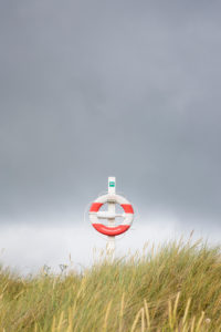 Lifebuoy in front of storm clouds on the beach of Vester Sømarken, Europe, Denmark, Bornholm, Lifebuoy in front of storm clouds on the beach of Vester Sømarken, Europe, Denmark, Bornholm,