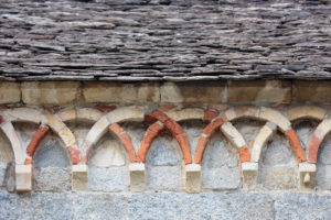 Europe, Italy, Piedmont, Montorfano. Decorative arches below the roof of the Chiesa di San Giovanni Battista, one of the best-preserved Romanesque churches in the Lago Maggiore region. Europe, Italy, Piedmont, Montorfano. Decorative arches below the roof of the Chiesa di San Giovanni Battista, one of the best-preserved Romanesque churches in the Lago Maggiore region.