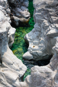 Europe, Switzerland, Ticino, Vallemaggia. The bed of the Maggia, cut deep into the rock and glowing in the sun. Europe, Switzerland, Ticino, Vallemaggia. The bed of the Maggia, cut deep into the rock and glowing in the sun.